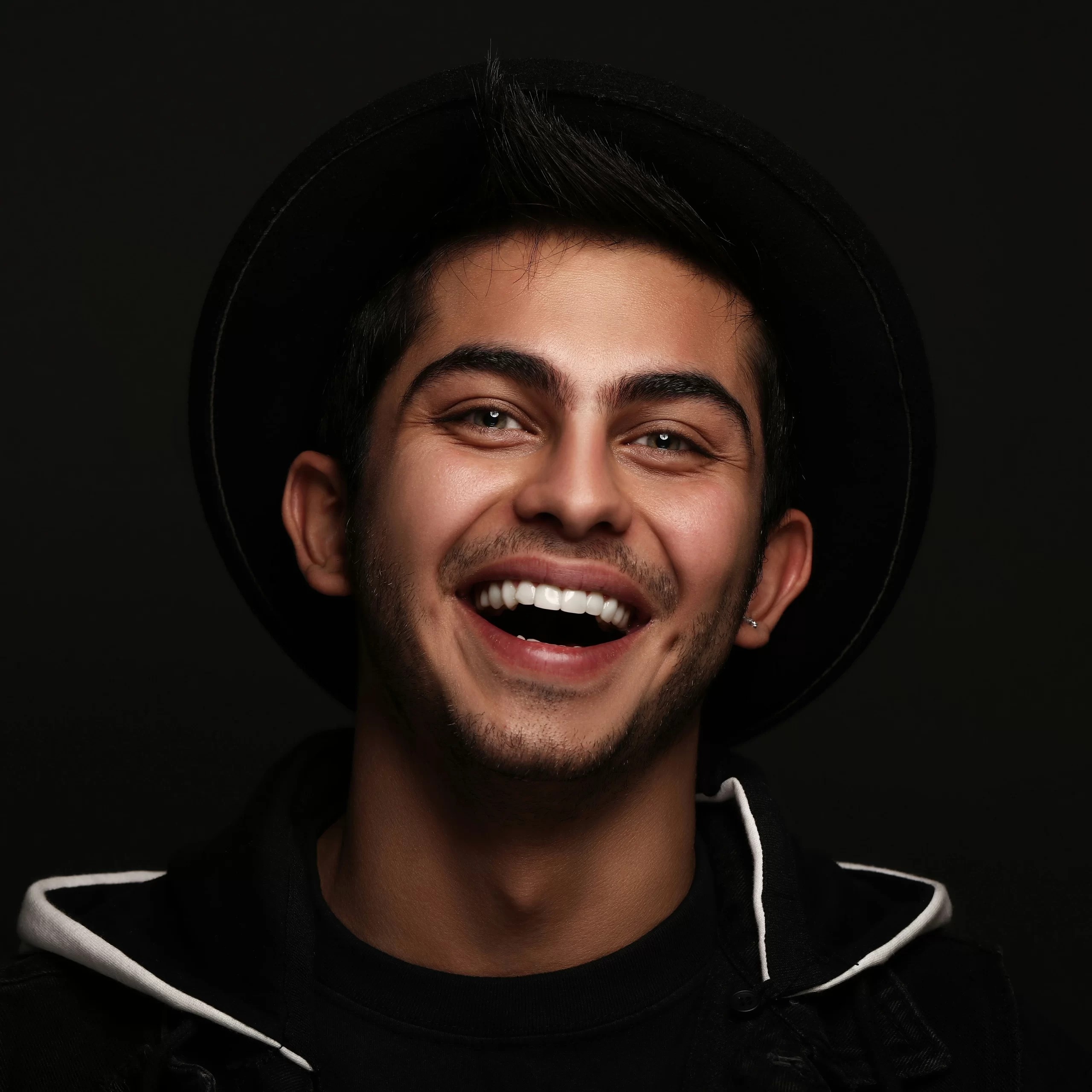 Man smiling confidently after teeth whitening treatment