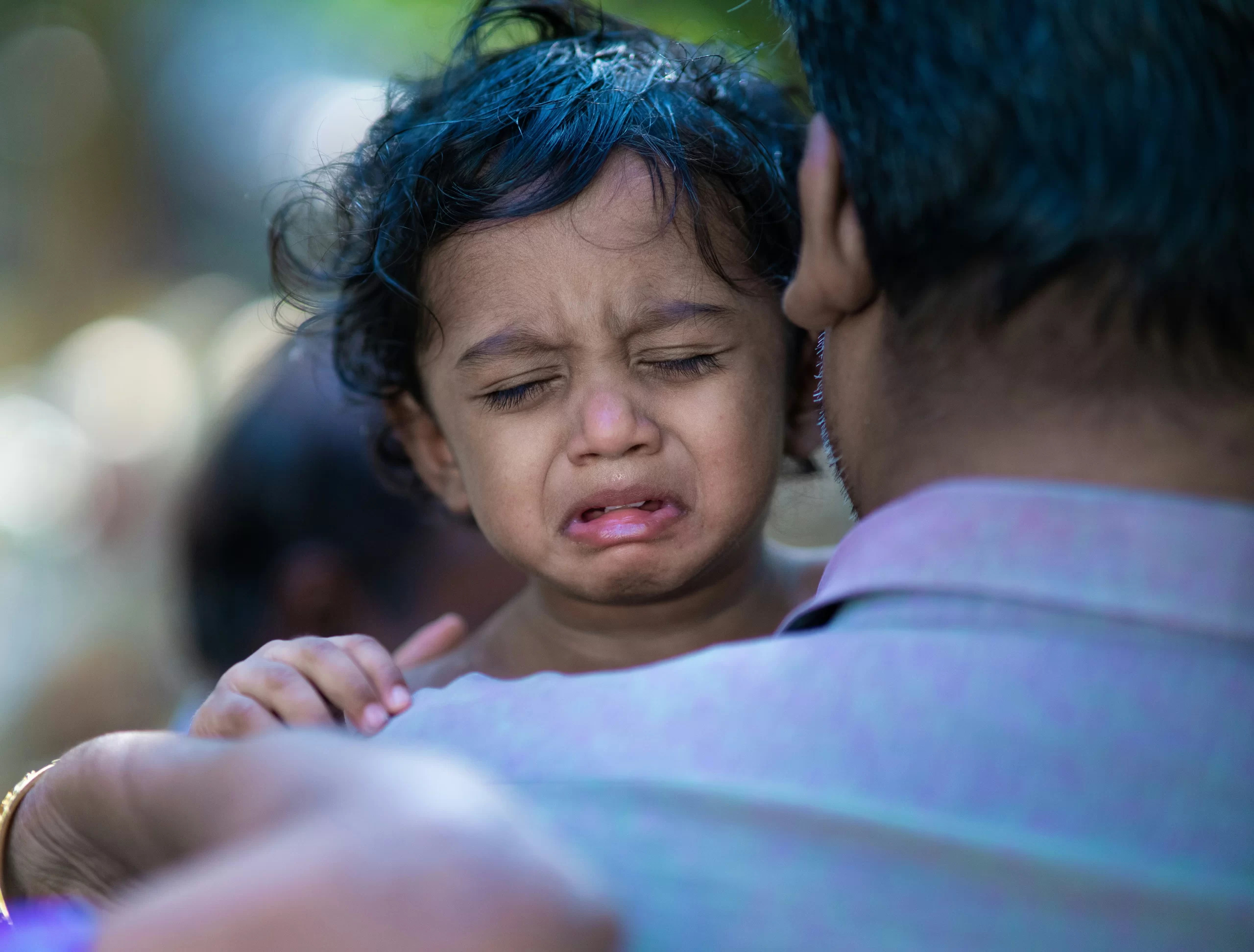 A crying child because of dental emergency pain.