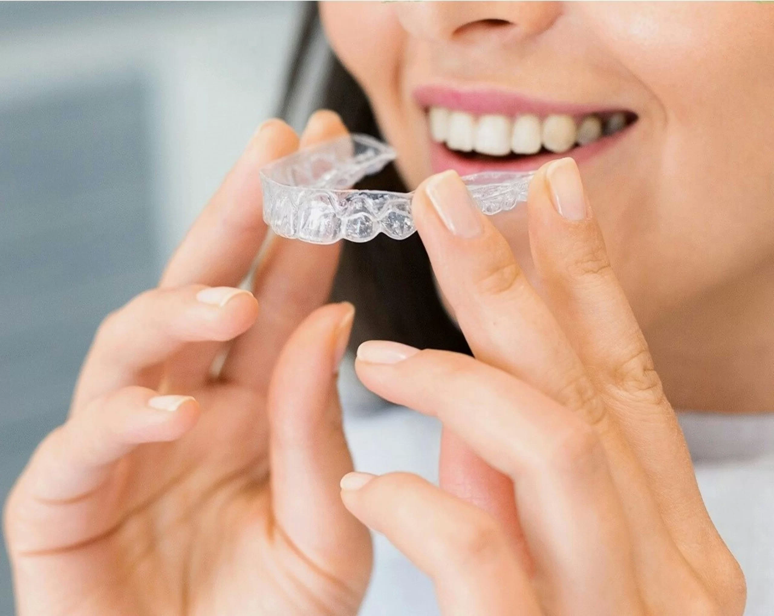 A woman wearing her invisalign.